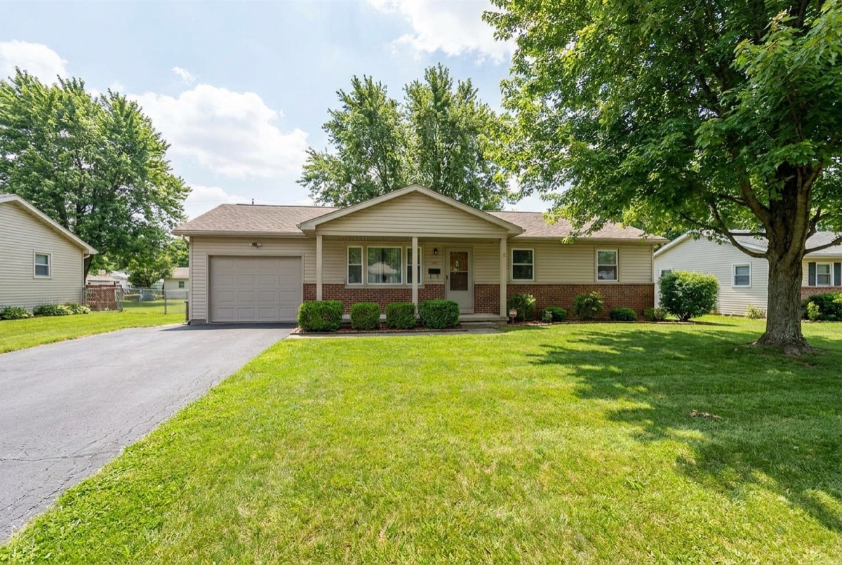 A suburban house exterior representing a shared home being sold